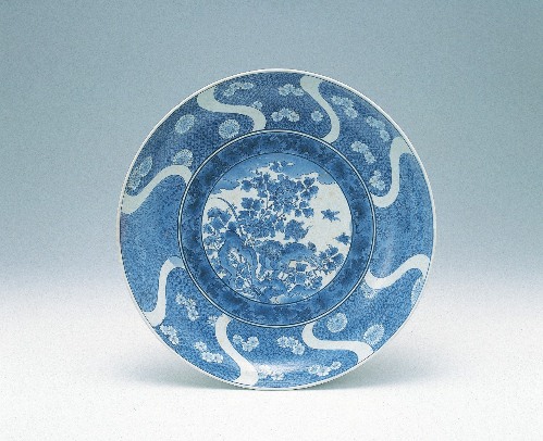 Large dish with Chinese lion, peony, cherry blossoms, chrysanthemum flower, and plum design in underglaze cobalt blue