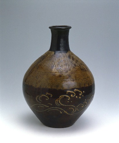 Large bottle with combed pattern and wave crest design in brown glaze
